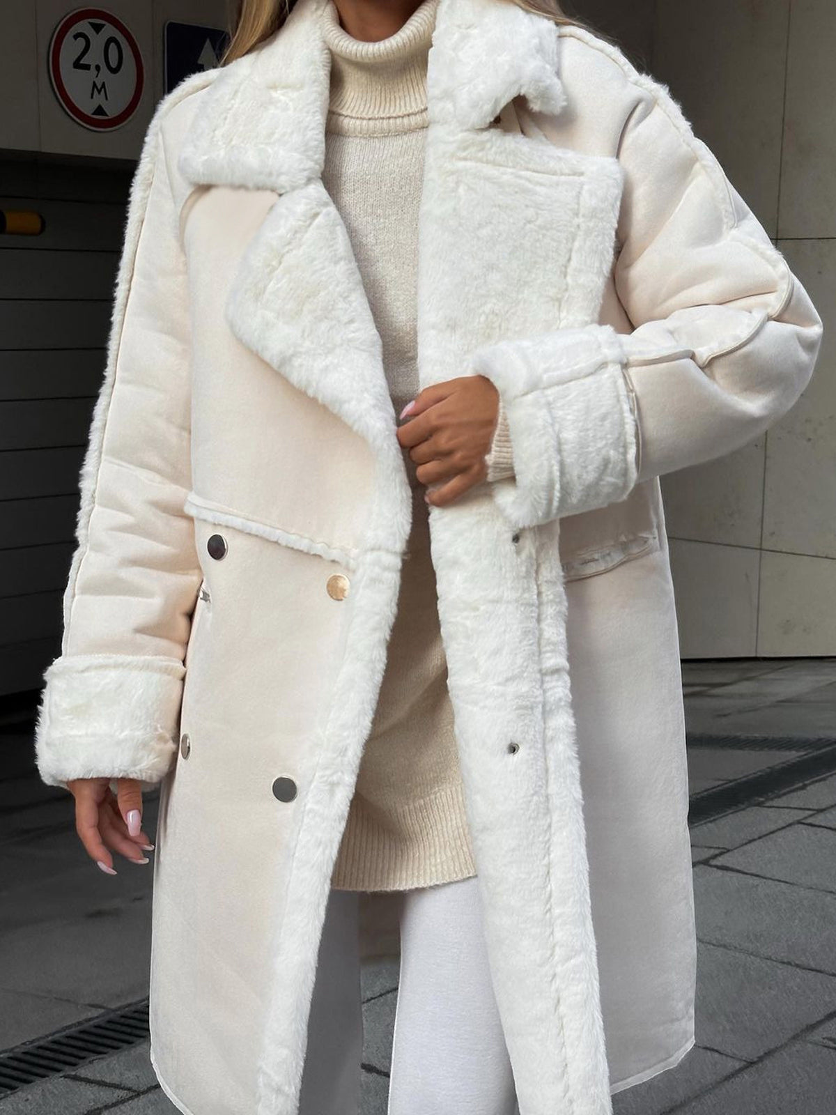 Model wearing beige plush-lined women’s coat