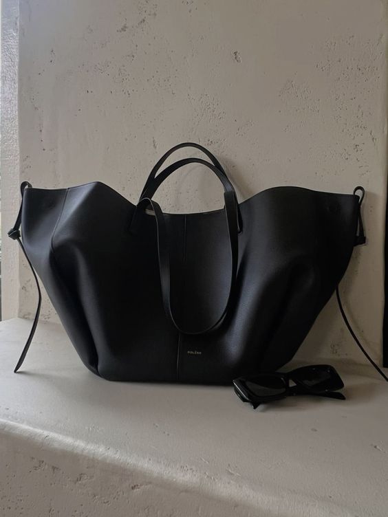 Black leather work tote - interior view showing organizational pockets and spacious design