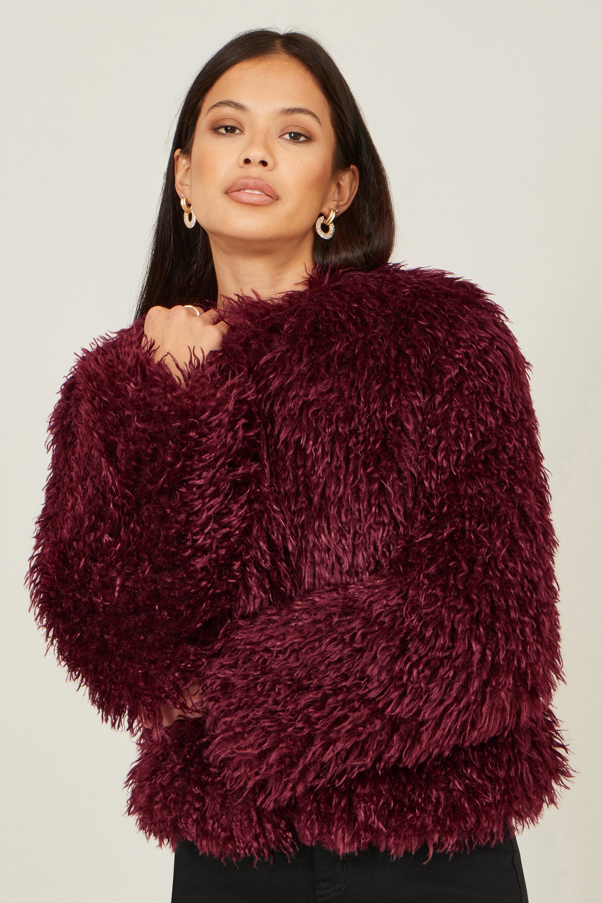 Burgundy faux fur coat interior showing polyester lining and quality construction