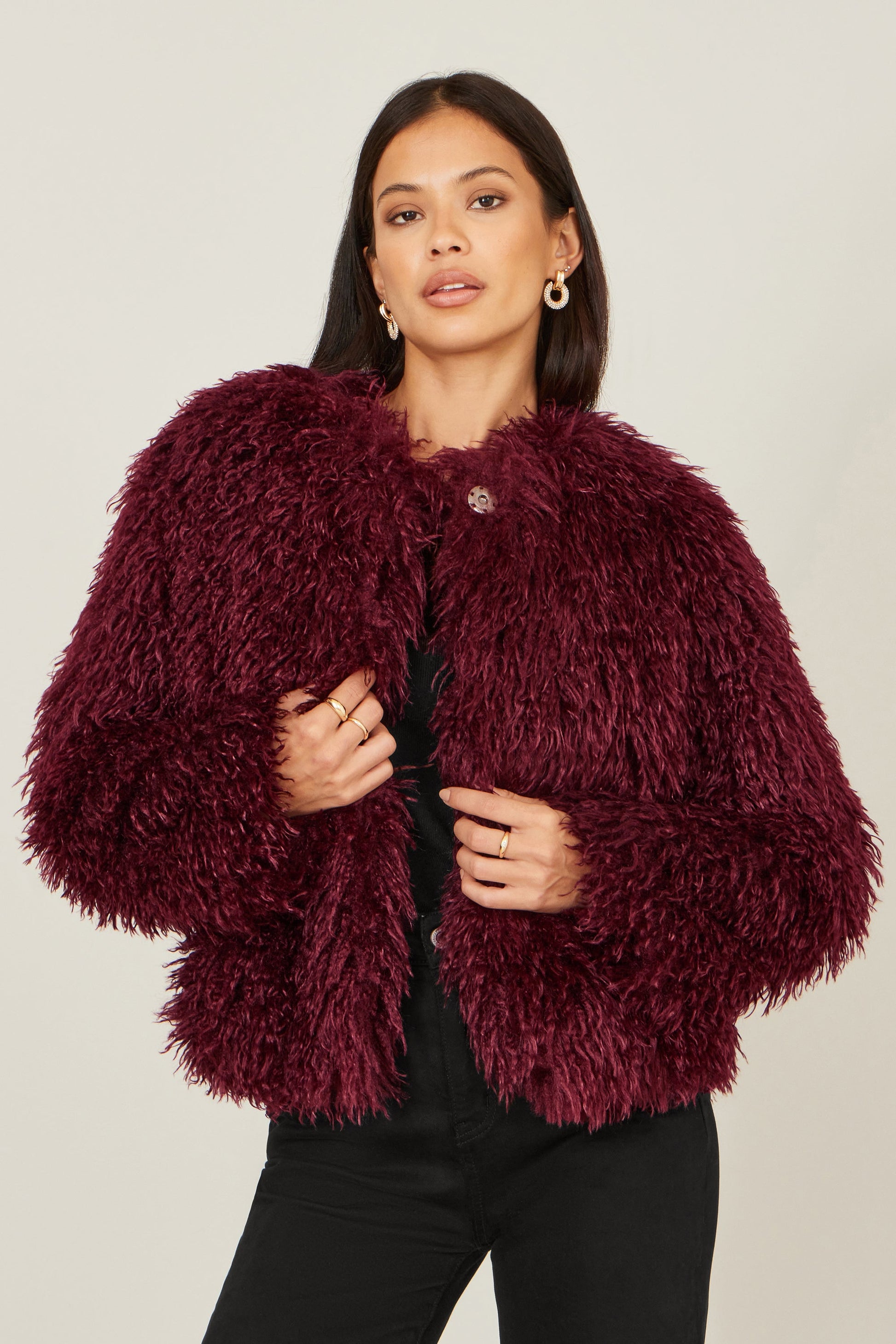 Burgundy fluffy faux fur coat with extra long length and luxurious texture for party season