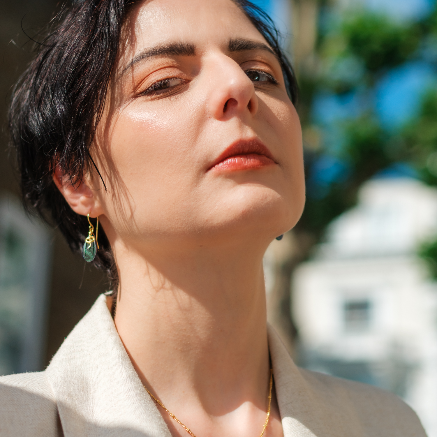 Handcrafted gold plated earrings featuring natural malachite stone and Medusa-inspired design