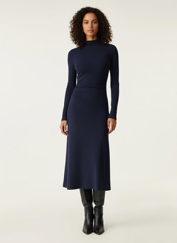 Woman wearing a navy blue dress on a white background
